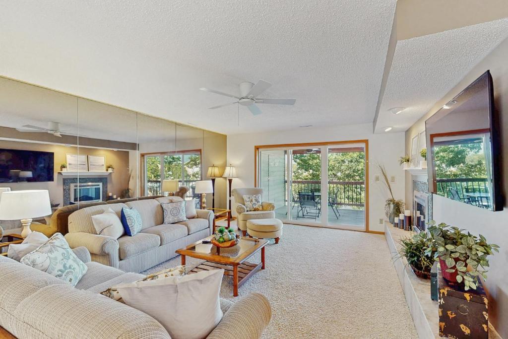 a living room with two couches and a table at Whispering Breeze Condo in Laguna Beach
