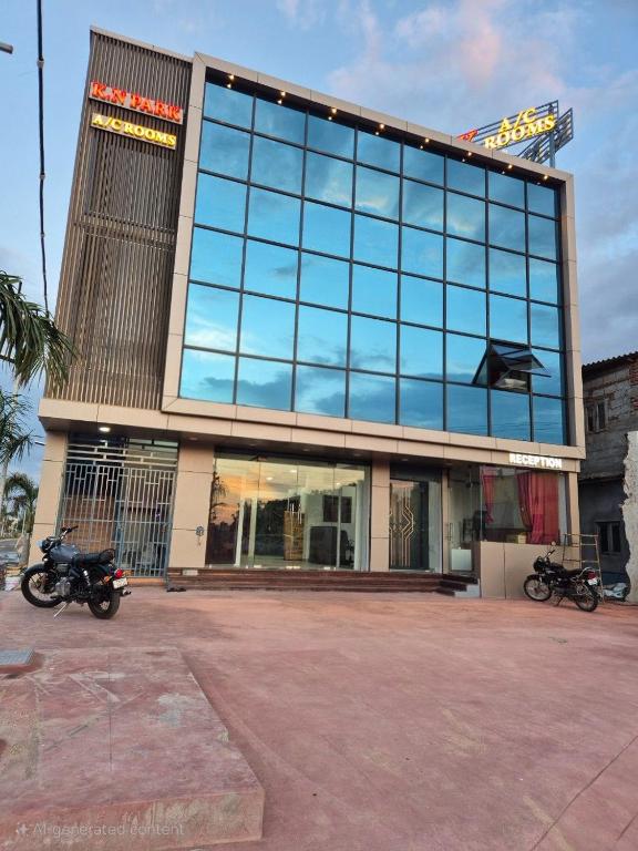 a building with two motorcycles parked in front of it at KN Park in Tiruchirappalli