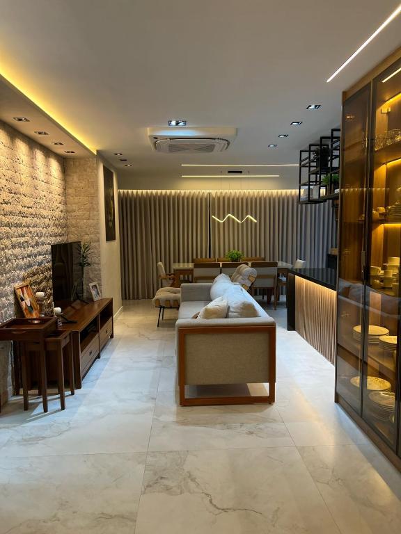 a lobby of a store with a couch and a table at Beautiful Apartment cop30 in Belém