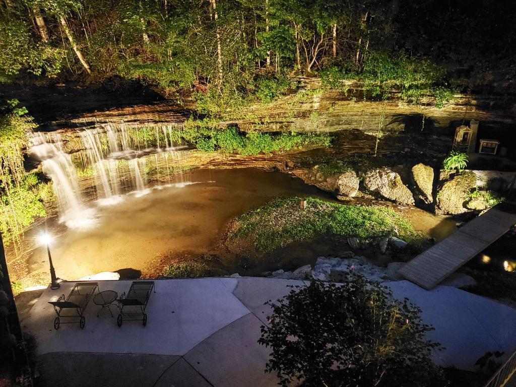 a view of a waterfall with two chairs in front of it at The Loft at Old Falls in Primm Springs