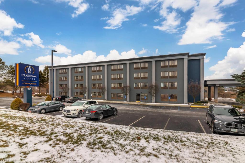 a parking lot with cars parked in front of a building at The Clocktower Hotel, an Ascend Collection Hotel in Cohoes