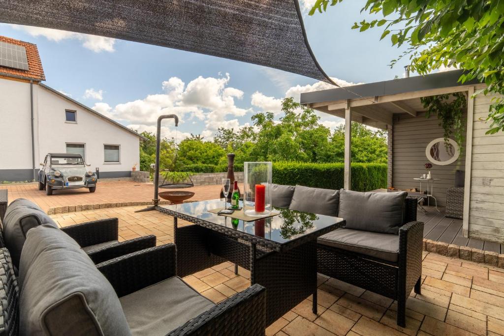 a patio with a couch and a table at Kleines Backhaus in der Eifel in Feuerscheid