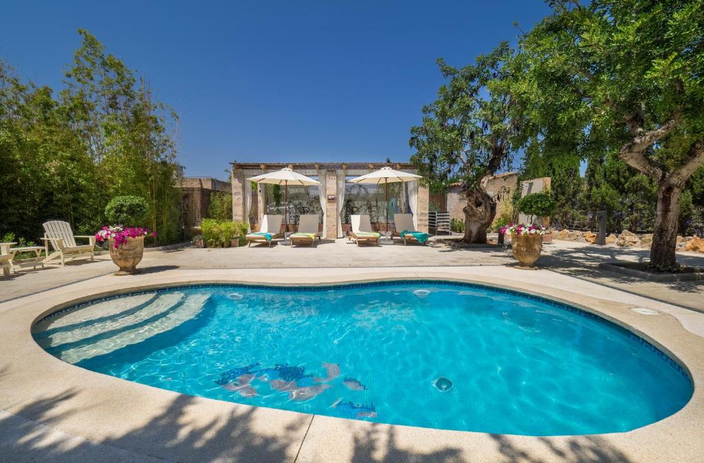 a swimming pool in the middle of a yard at Protur Residencia Son Floriana in Cala Bona