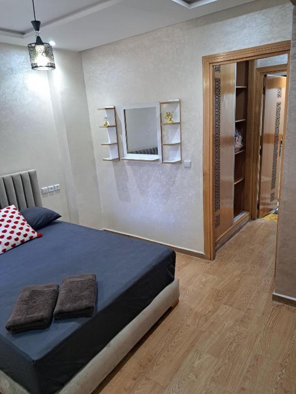 a bedroom with a bed and a mirror on the wall at Nabiloc Apart Hotel - Centre Ville in Fez