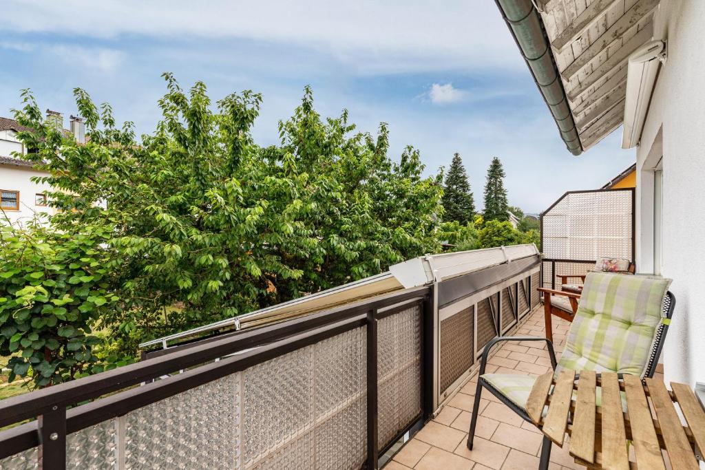a balcony with a chair and a view of trees at Sonnenschein in Zell am Harmersbach