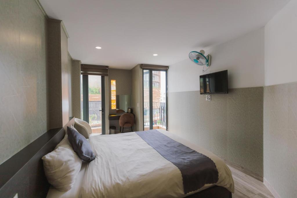 Ένα ή περισσότερα κρεβάτια σε δωμάτιο στο Estella Hotel Dalat