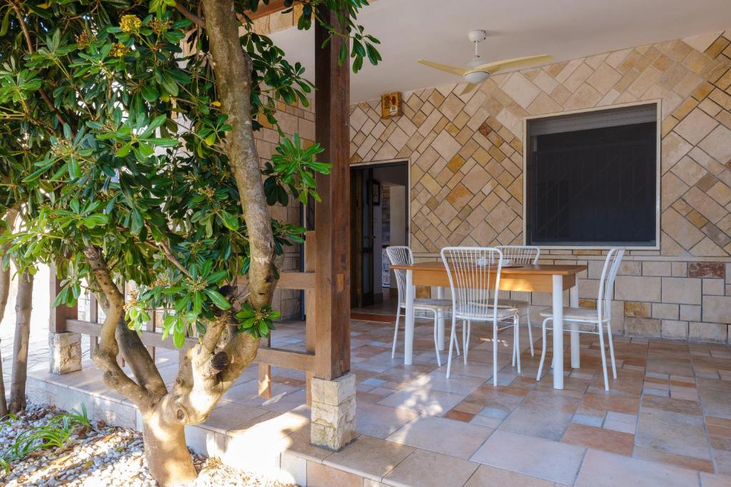 a patio with a table and chairs and a screen at Villa Assunta in Torre rinalda