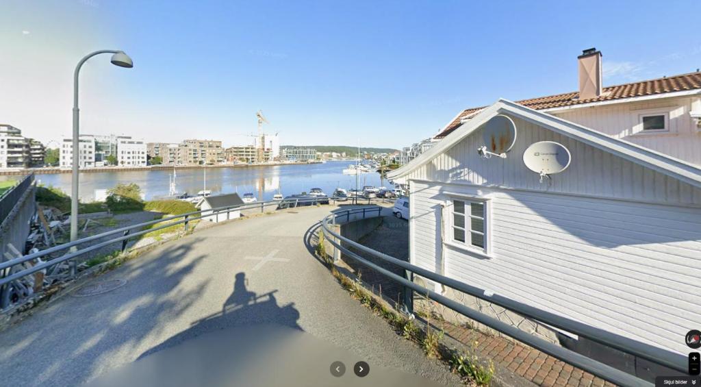 a shadow of a person on the side of a building at Bright and centrally studio with Oceanview in Kristiansand