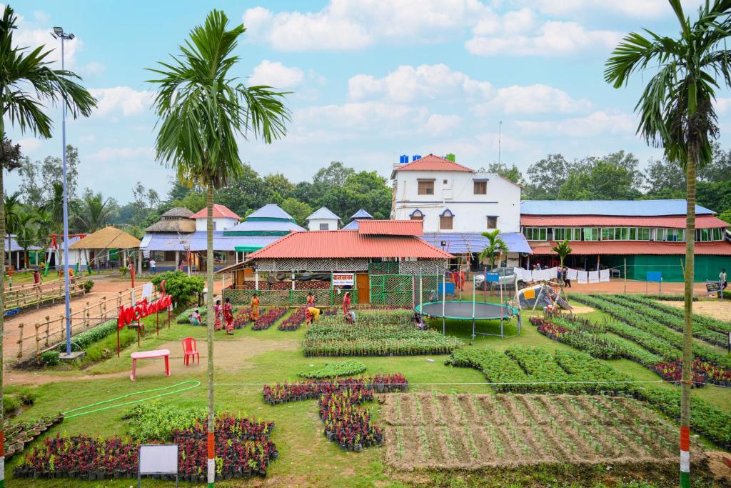 a park in front of a building with a garden at Banalata Resort in Jaypur