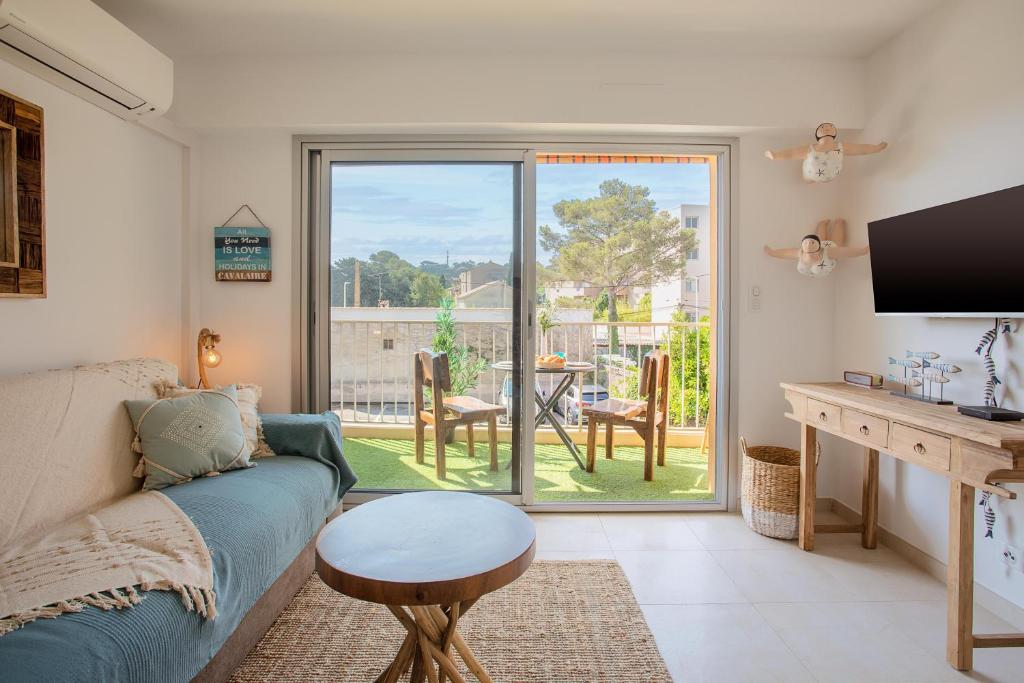 a living room with a couch and a table at Studio Golfe de Saint Tropez in Cavalaire-sur-Mer
