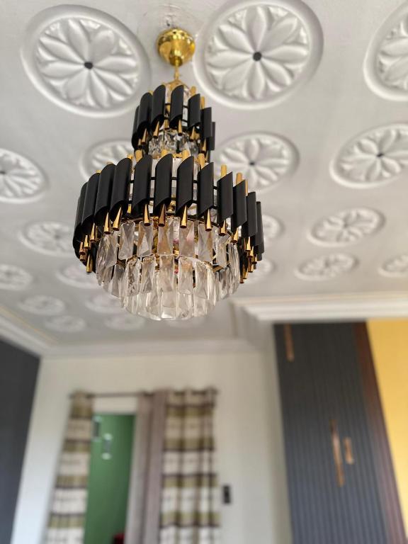 a chandelier hanging from a ceiling in a room at RBNB by MELUSH in Cotonou