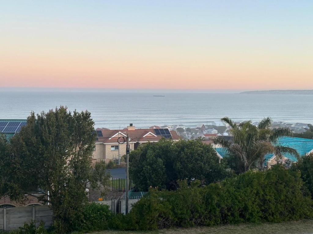 a view of a city and the ocean at sunset at SEE n BERG RUSPLEK in Tergniet