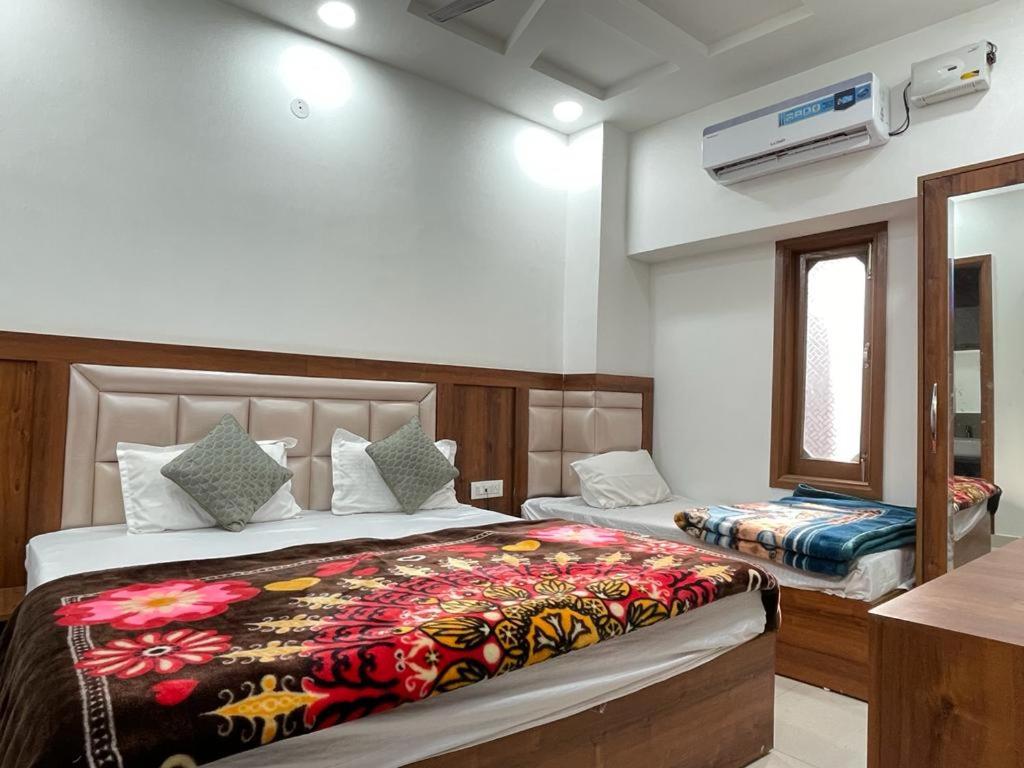 a bedroom with two beds and a window at Sonu luxury residency hotel in Amritsar