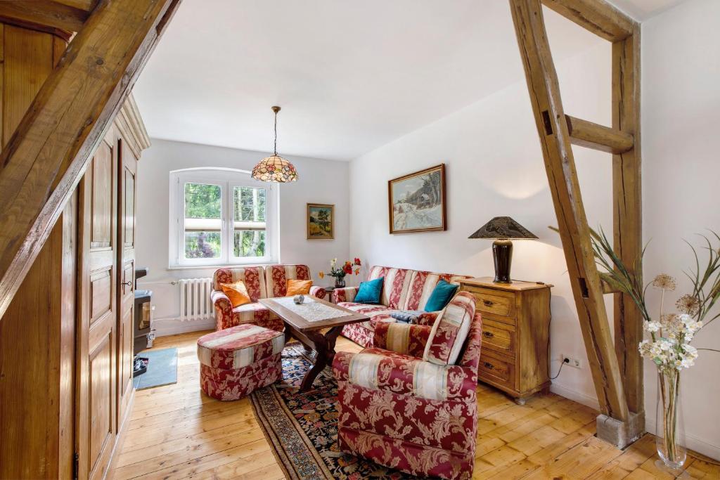 a living room with a couch and a table at Ferienhaus Waldliebe in Hüttenrode