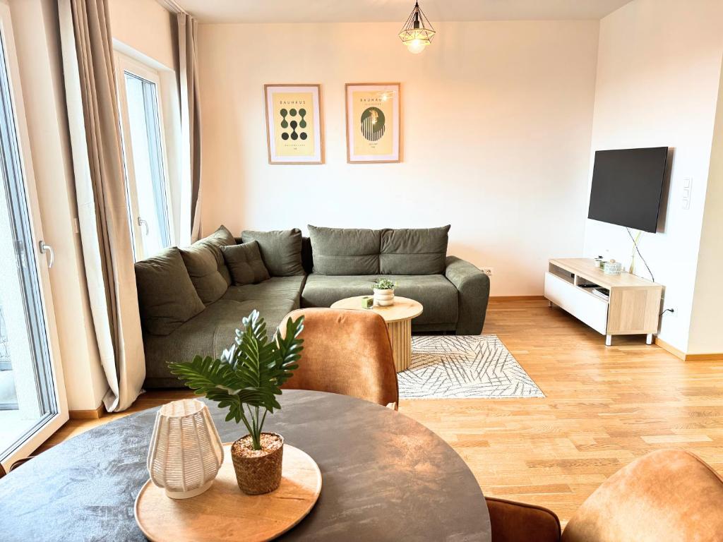 a living room with a couch and a table at Lake View Suite in Mörbisch am See