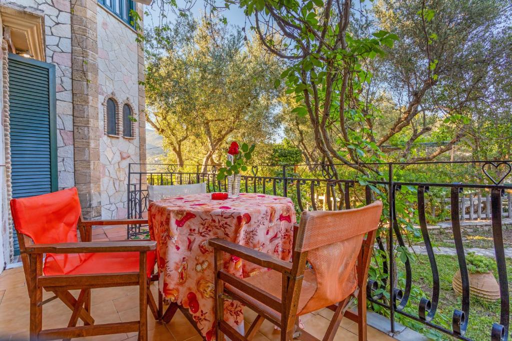 a table and two chairs on a balcony with a table and chairsktop at Castellos Bellos Studio 2 in Marathias