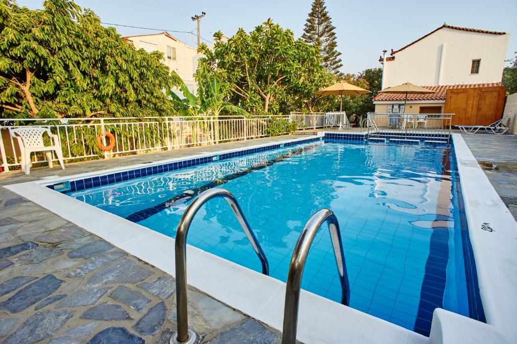 a swimming pool with blue water in a house at Christinantzela Apartments in Kokkari