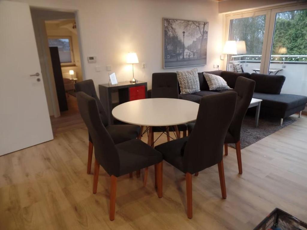 a living room with a table and chairs and a couch at Gemütliche Dachgeschoss Wohnung in Selm