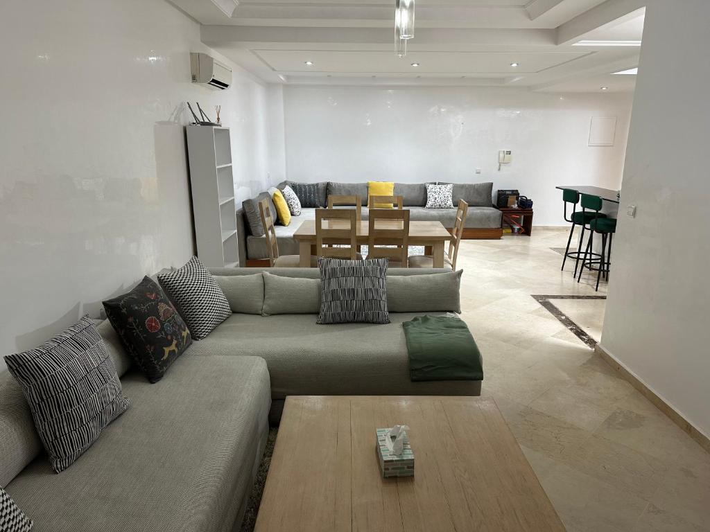 a living room with a couch and a table at Appartement Haut standing in Mohammedia