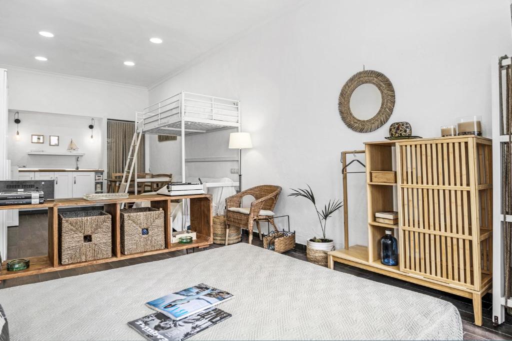 a living room with white walls and wooden furniture at La Casita Blanca in Barbate