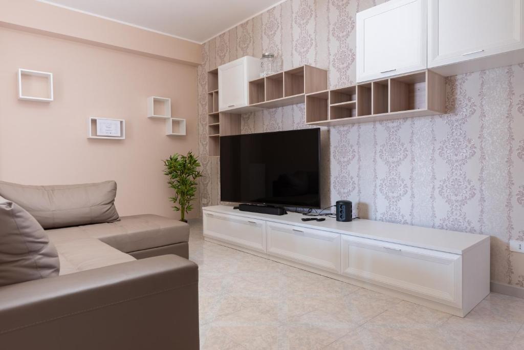 a living room with a couch and a flat screen tv at Casa Vacanze Francesco Pulsano in Pulsano