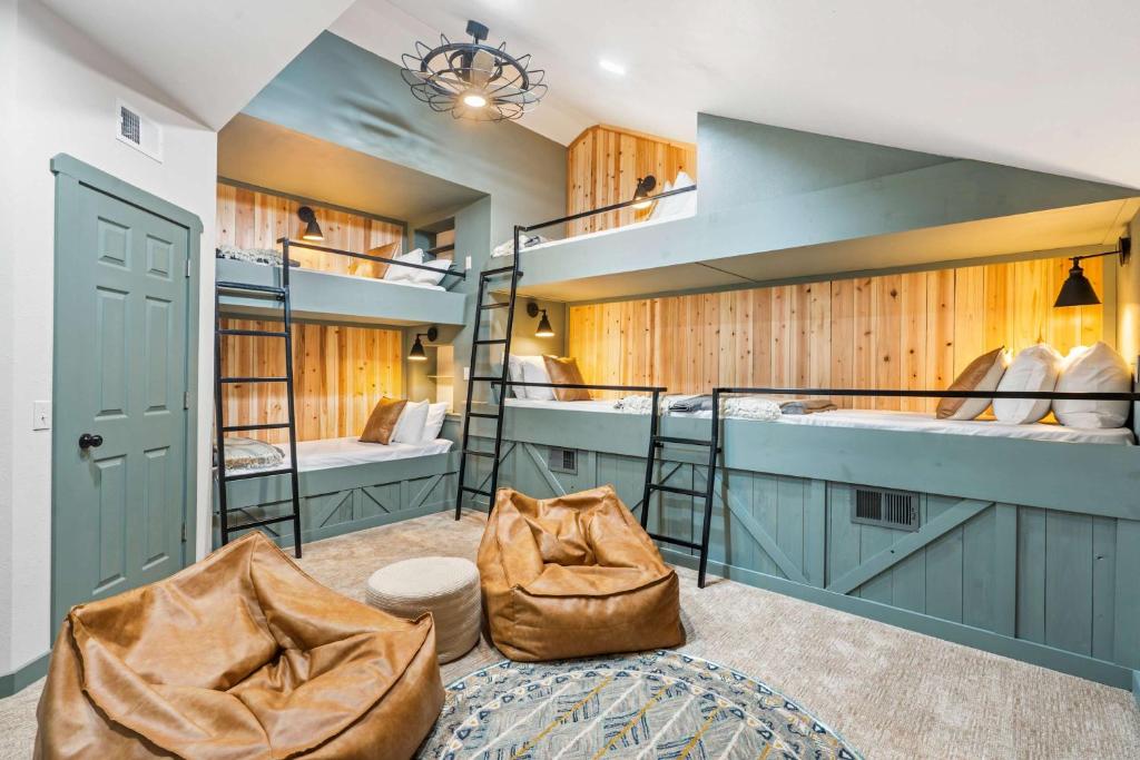 a room with two bunk beds and a staircase at Penthouse 7 on Taneycomo - Chic Waterfront Condo in Branson