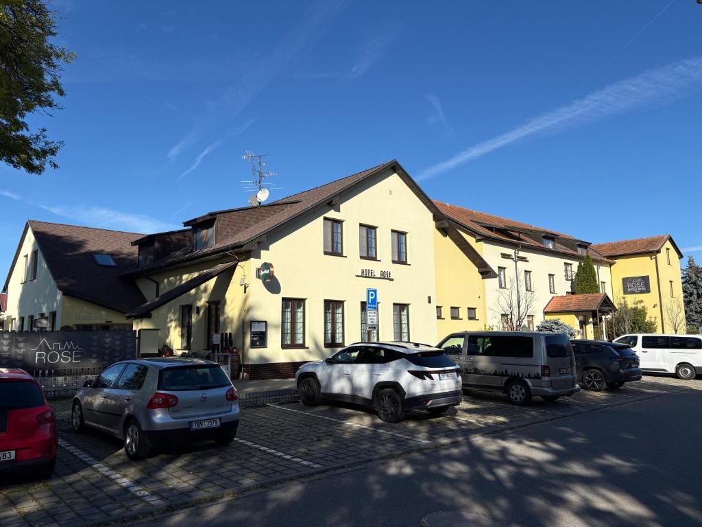 a group of cars parked in front of a building at Hotel ROSE Břeclav in Břeclav