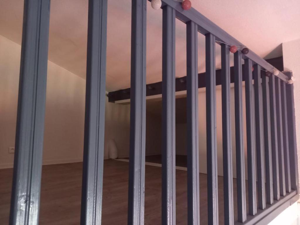 a metal railing on a staircase in a room at Appartement B in Théoule-sur-Mer