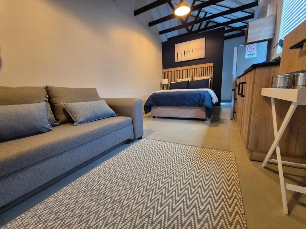 a living room with a couch and a bed at atnine in Welkom