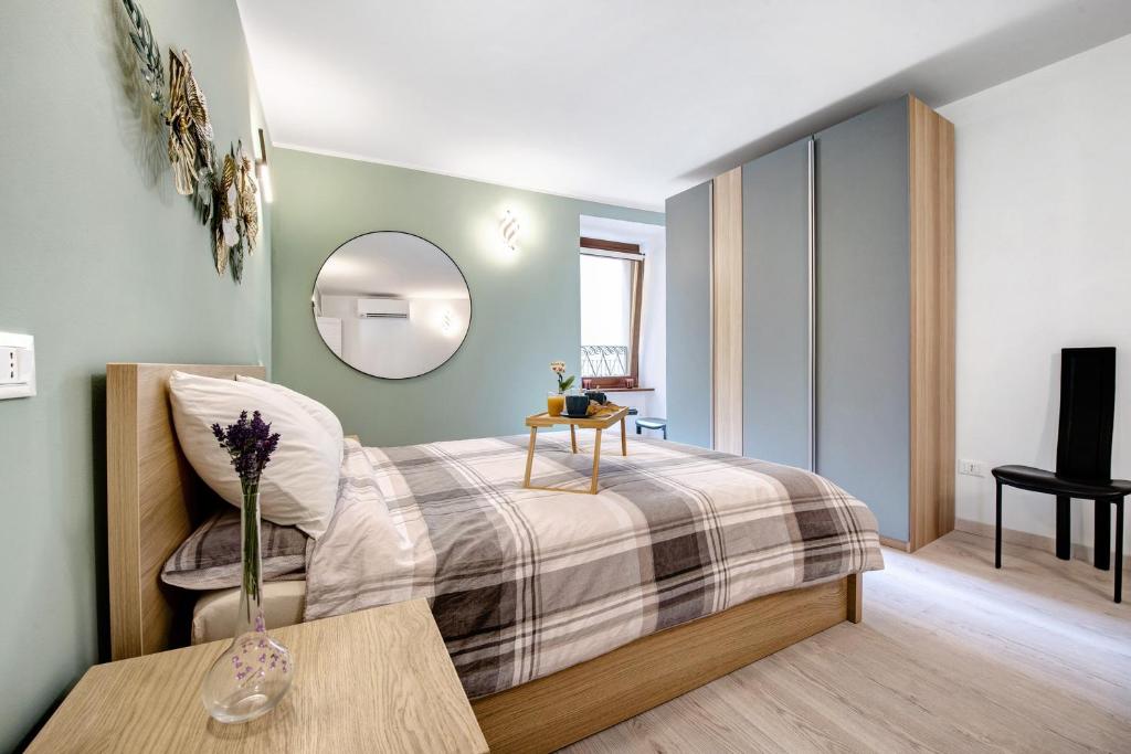 a bedroom with a bed with a table and a mirror at Le Lavande in Castro