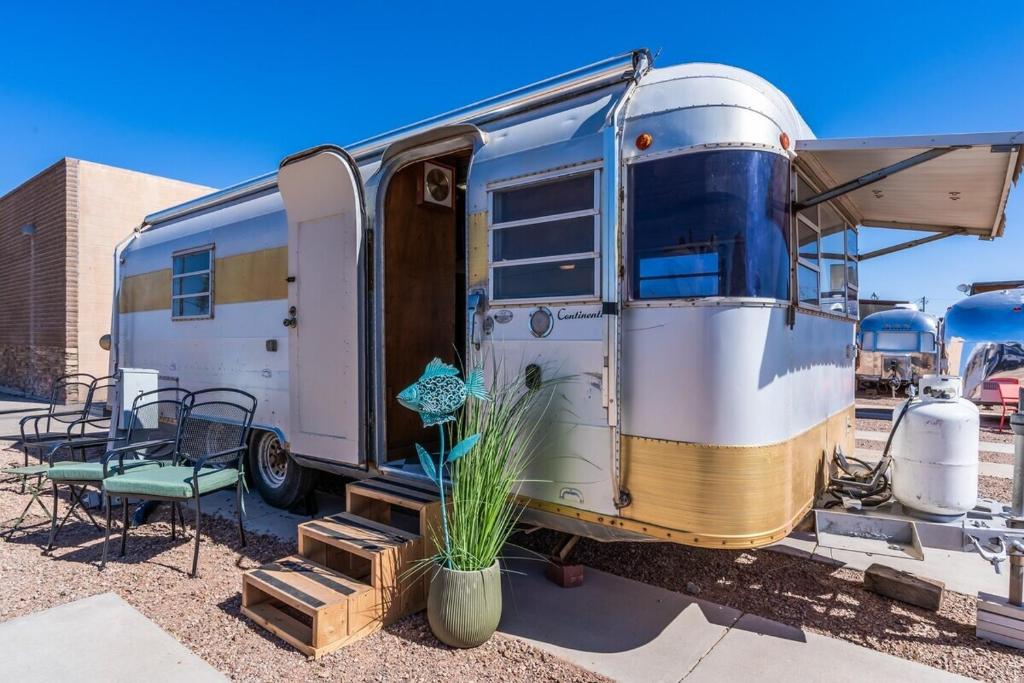 an old rv parked in a parking lot at SS Mindy - A Unique Tombstone Stay in Tombstone