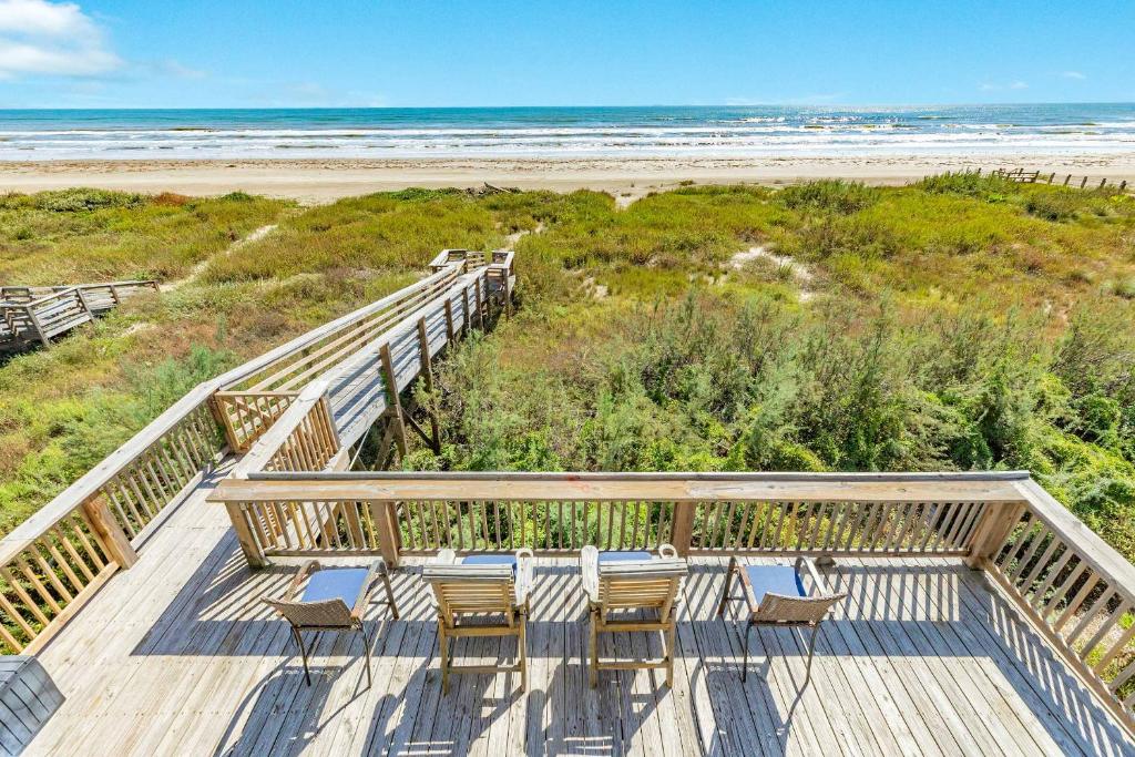a deck with chairs and a view of the beach at Blue Waves - Beachside Calm, Gulf Views for Miles in Freeport