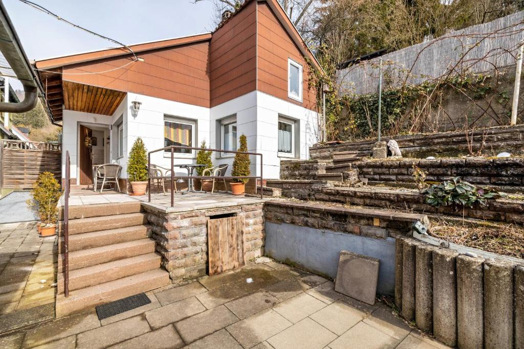 a home with a small house with a patio at Ferienwohnung Behrens-Reinke in Albstadt