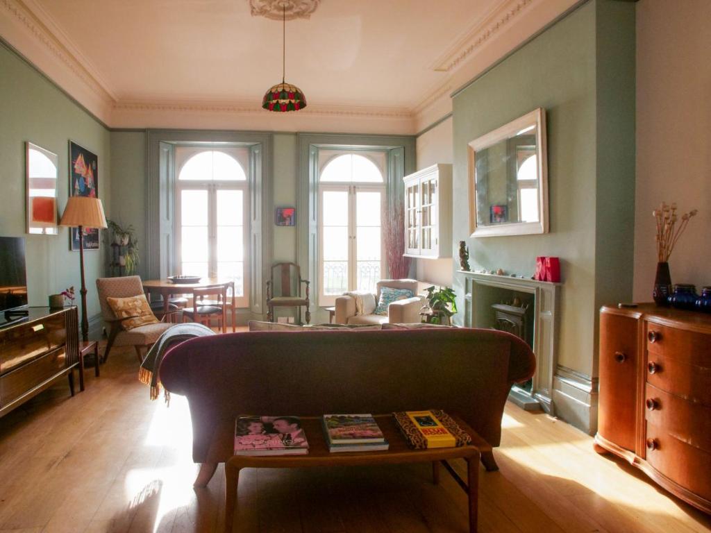 a living room with a couch and a table at Beautiful sea front apartment with balcony in St Leonards-on-Sea in Hollington