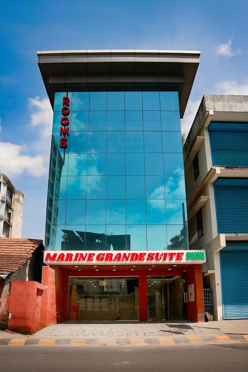 a building with a sign on the side of it at Marine Grand Suite in Cochin