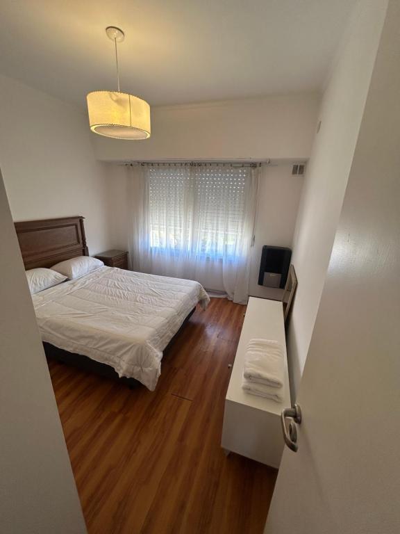 a bedroom with a bed and a table and a window at Depto 3 de Febrero 235 in Venado Tuerto