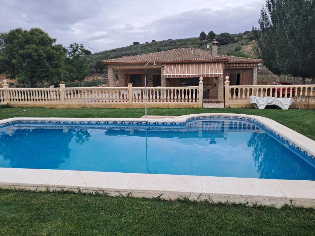 a swimming pool in the yard of a house at casa rural Hachuelo in Montefrío