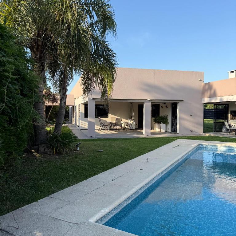a swimming pool in front of a house at Sumergite en una gran piscina o jacuzzi in Gualeguaychú