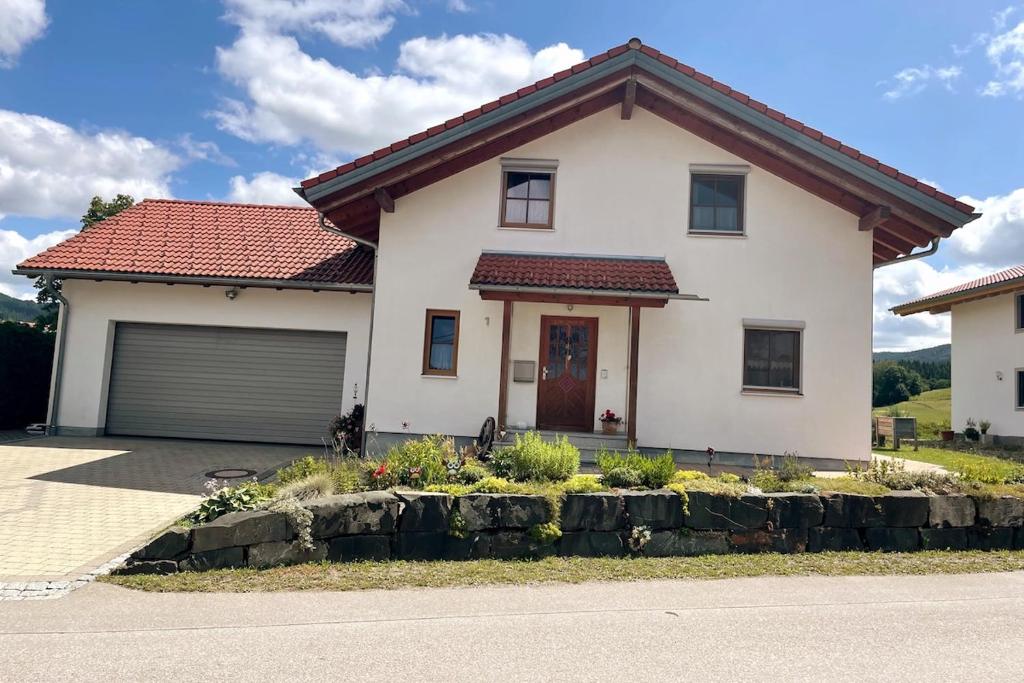 a white house with a red roof at Ferienhaus Eugler in Weitnau
