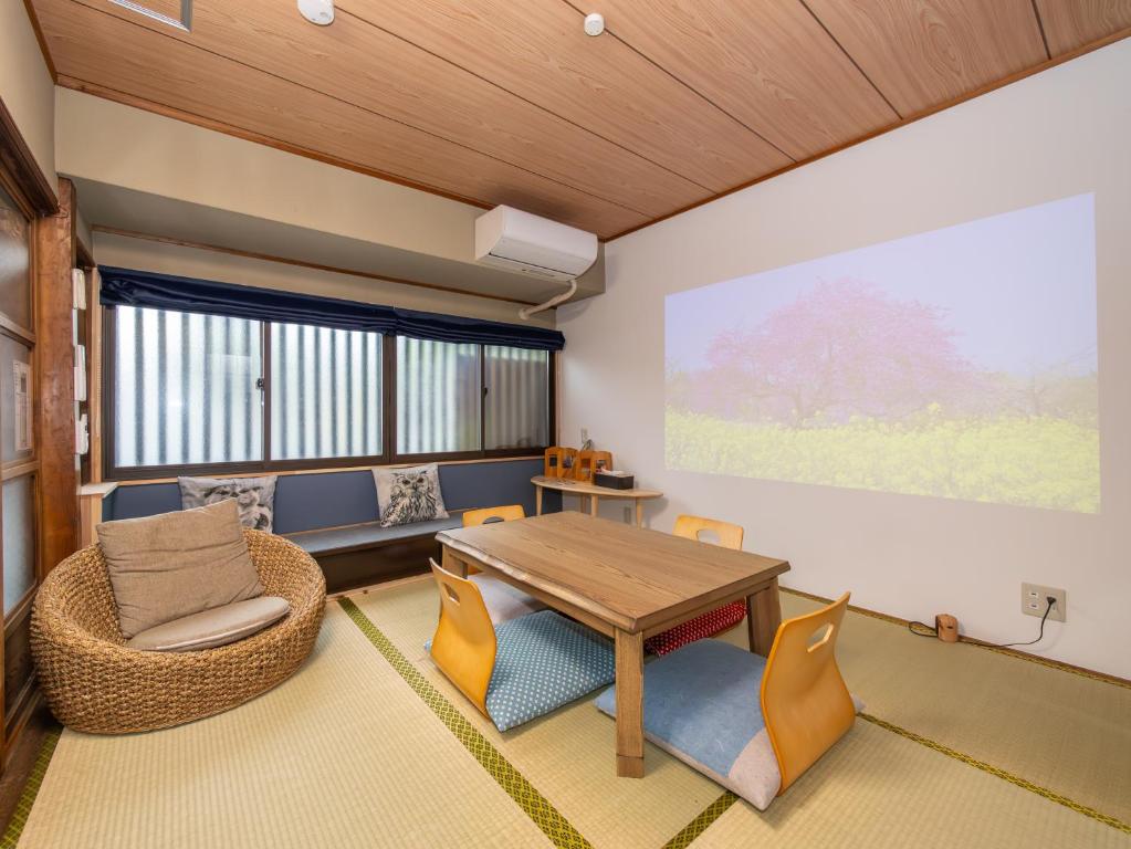 a living room with a table and chairs at kyomachiya-京町家Oneworld十条-Jujo in Kyoto