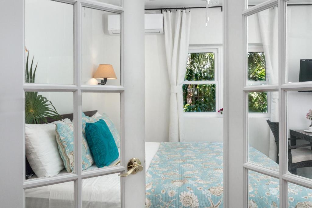 a room with a door with a bed and a table at Karana Studio 2 - K2 in Long Bay Hills