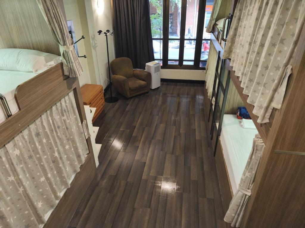 a room with two bunk beds and a chair at Barcelona & You Hostel Sagrada Familia in Barcelona
