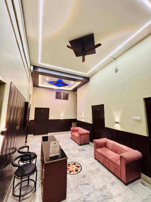 a lobby with a couch and chairs and a ceiling at Shree Balaji Comfort - Free Parking in Varanasi