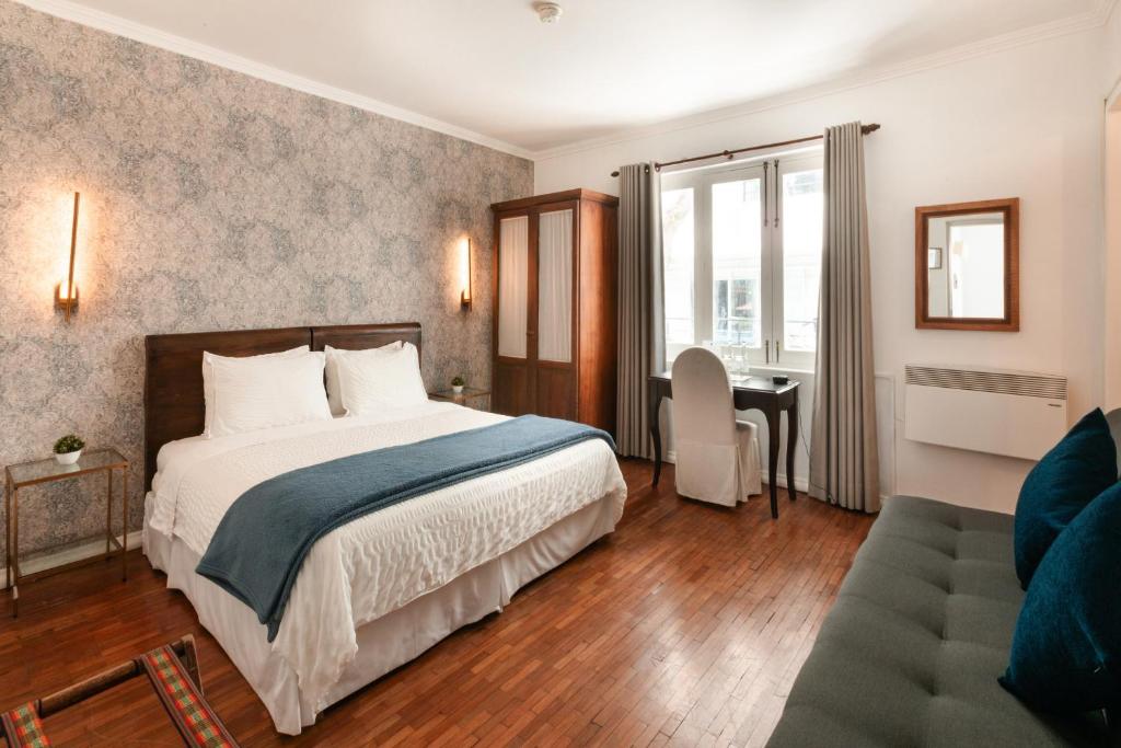 a hotel room with a bed and a desk at La Rabida Hotel Boutique in Quito