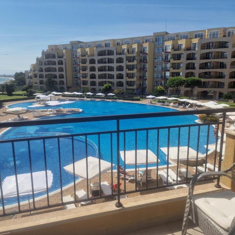 a view of a swimming pool from a balcony at Charming Studio at the Seaside in Aheloy