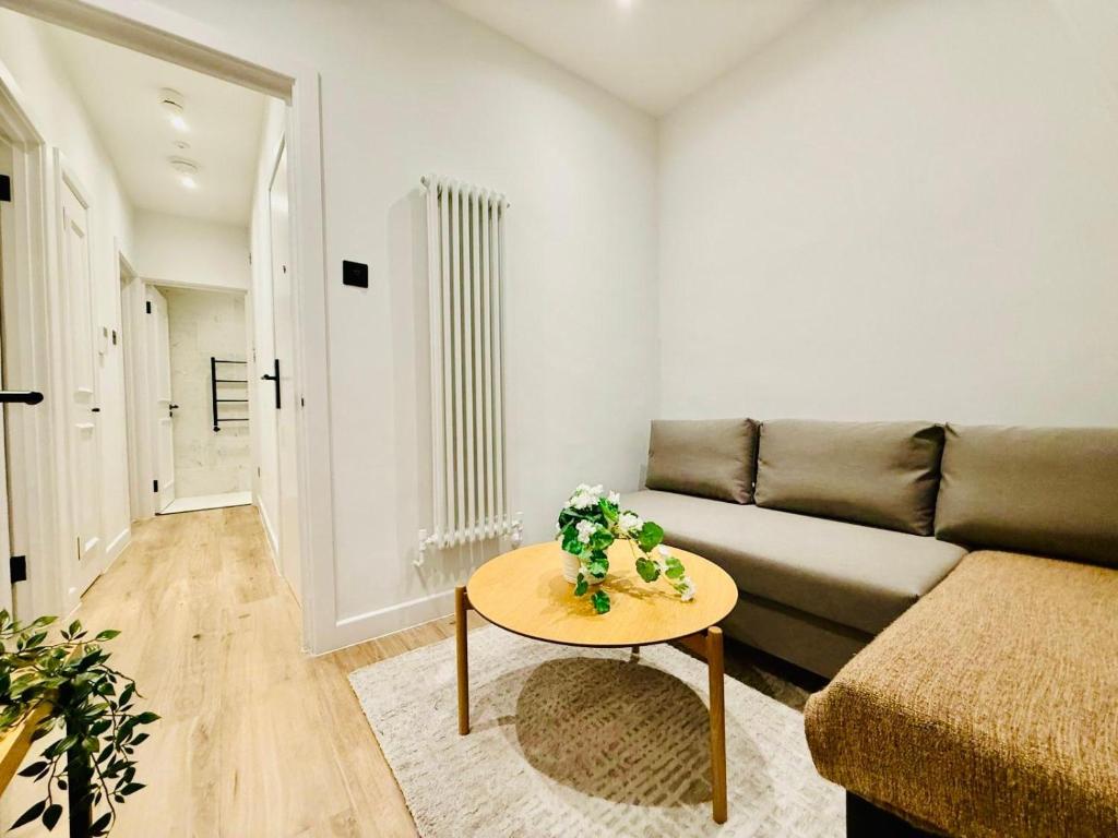 a living room with a couch and a table at Old Compton Apartments in London