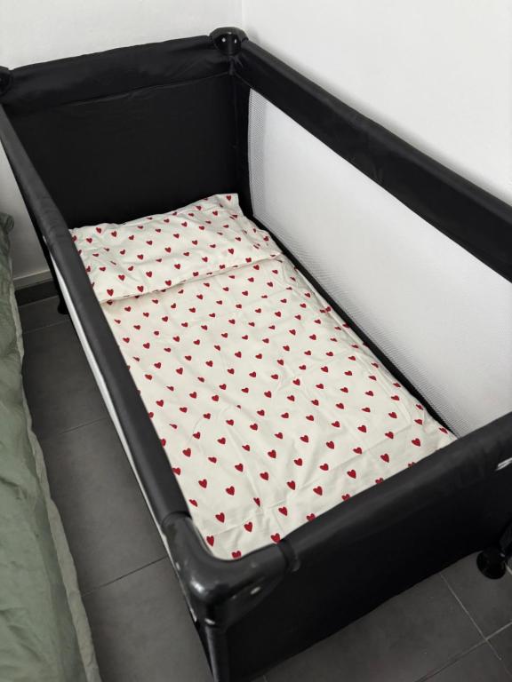 a bed frame with a mattress with hearts on it at Chez Aurore in Port-de-Bouc