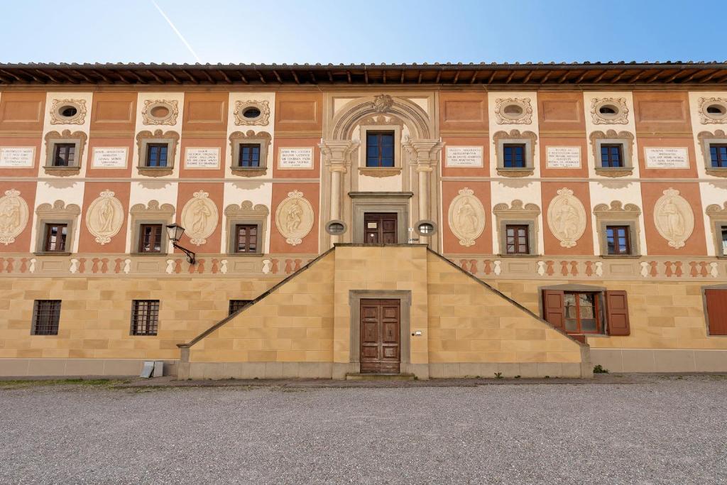 a large building with a staircase in front of it at Le Dimore del Seminario in San Miniato