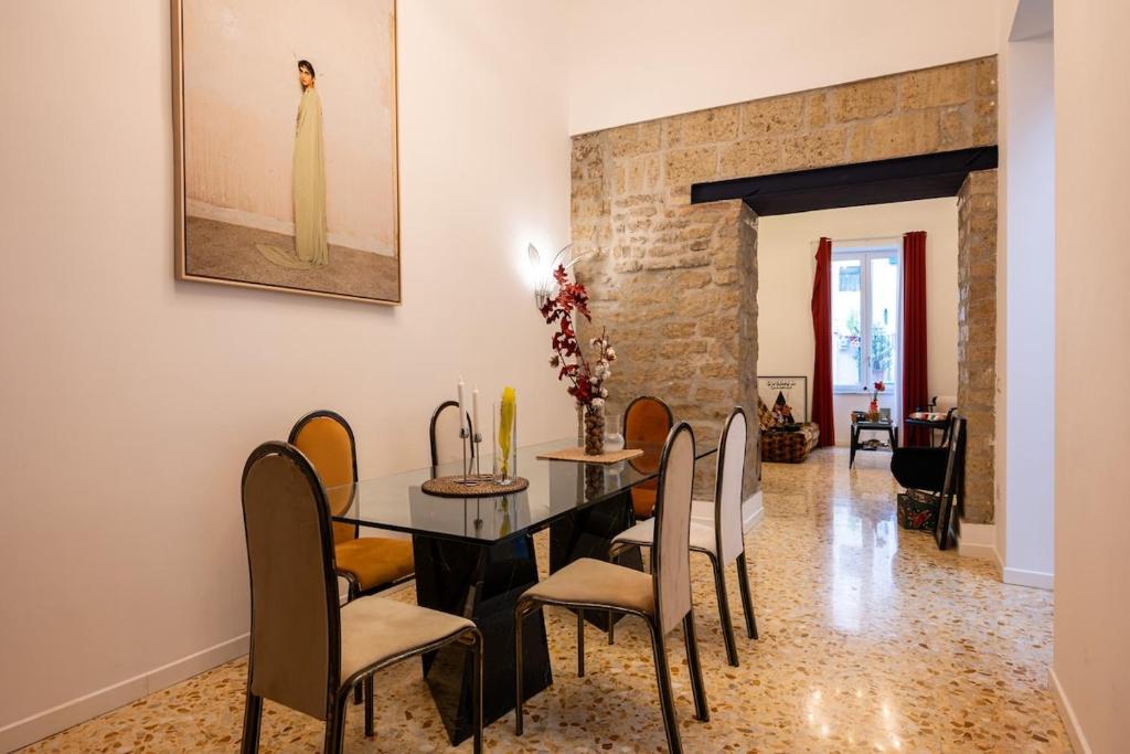 a dining room with a table and chairs at Maison Noir Napoli in Naples