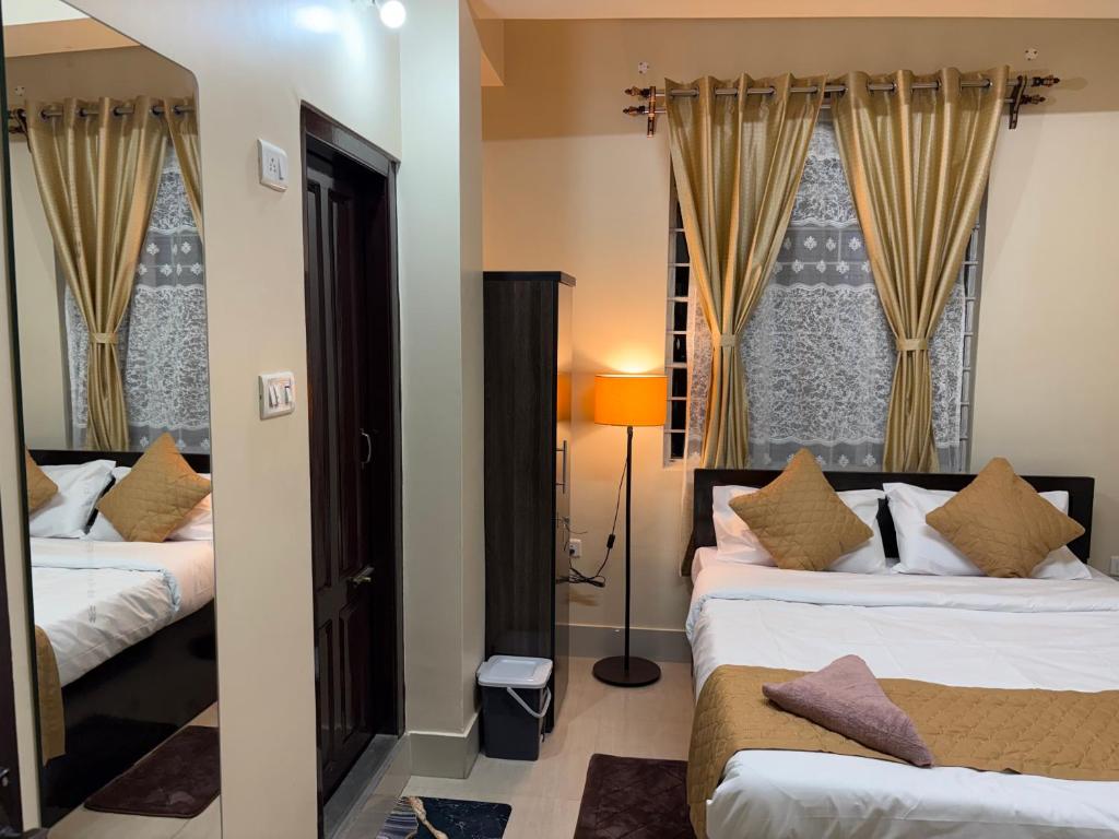a hotel room with two beds and a window at The urban rest in Shillong